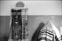 Saying the blessing for donning the tallit at morning services in the only Beit Midrash in Warsaw, adjacent to the unused Nozyk Synagogue. The Nozyk remained unused, too big and too cold for the few people who came to pray. 1979