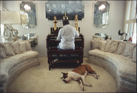 Count Basie playing organ in his living room with dog Graf (Count in German).