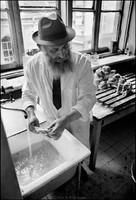 Moshe Shapiro, of Warsaw's kosher kitchen, washing meat. Shapiro, the kitchen's ritual slaughterer, was overseer to the cleanliness of both the food and kitchen according to Jewish law.  Money for the food and operation of the kitchen came from the American Jewish Joint Distribution Committee.  1975 