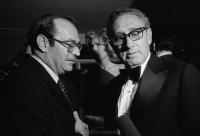 Secretary of State Henry Kissinger (r) and Israeli Ambassador to the United States Simcha Dinetz eyeing an intrusive microphone while in conversation.