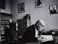 Researchers at the Jewish Historical Institute in Warsaw.  Scholarly works regarding Jewish culture, history are still being written here.  Pictures on the wall are (l-r) Shalom Aleichem (writer), Isaac Peretz (writer), Dr. Meir Balaban (historian of Polish Jewry, died in the Warsaw Ghetto, 1942), and Professor Ber Mark (historian and director of the institute until his death in 1966).  