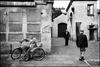 Arriving for Friday night services in the courtyard of Krakow's Remu Synagogue. Mr. Lemper in his tri-cycle. 1983 