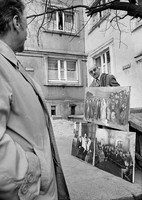 Jewish art dealer displaying 'supposed copies' of old paintings by Jewish artists,  In front of his Warsaw apartment building. 1979