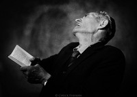 Pincus Szenicer, caretaker of Warsaw's Jewish Cemetery, reciting psalms for a recently deceased 74-year-old woman. 1975 