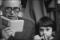 Moshe Abramson, with his daughter Mara, reading the Hagaddah at Passover Seder in Warsaw's kosher kitchen. 1979