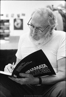 W. Eugene Smith in his 23rd street loft, inscribing his book "Minamata" to a young photographer.