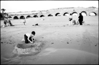 On the beach in Caesarea, I was digging because I like to dig and build things.  In the background are ancient Roman ruins.