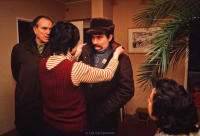 Lech Walesa receiving last minute advice and having his collar adjusted by wife Danuta, in their apartment before going off to work. Walesa's bodyguard, Henryk Mazul, next to him. Gdansk, Poland December 1980.
