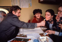 Lech Walesa lighting cigarettes for women who work at Solidarity
in his office at Solidarity headquarters, Gdansk, Poland. December 1980.