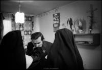 Lech Walesa kissing nuns hand in his office at Solidarity headquarters, Gdansk, Poland. December 1980
