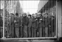 Shipyard workers watching preparations, from behind a shipyard gate, for the opening of the Monument for the Fallen 1970, Gdansk, Poland, December 1980.