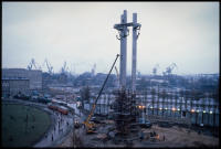 Monument for the Fallen of 1970 being completed for its unveiling, with Lenin shipyard in background, Gdansk, Poland, Dec 1980