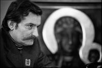 Lech Walesa with painting of Black Madonna of Czestochowa, Poland's emblem of protection since 1655, in his office at Solidarity headquarters, Gdansk, Poland. December 1980. The pin on his lapel is also of the Black Madonna.