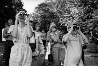 Susan and Adam Fishman (binoculars) watching the burning smoke from the collapsed World Trade Centers, 37 miles away, from a mountain top with other residents of Rockland County, NY,  Sept. 11, 2001