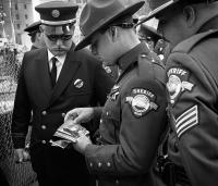 Sherriffs from Oregon looking at photos from a year earlier at the first anniversary of the attack at the World Trade Center at Ground Zero, NY, NY, Sept. 11, 2002