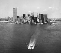 Aerial view of New York harbor and lower Manhattan skyline with boat in foreground, New York, New York, August 1978